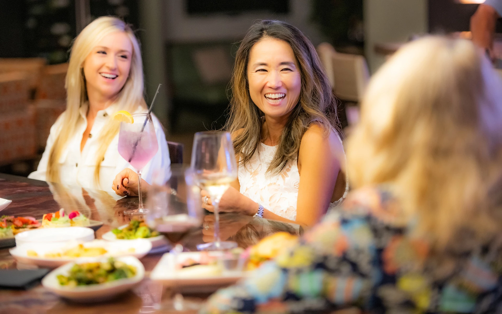 Ardea members laughing over dinner